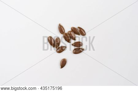Flax Seeds Isolated On White Background. Top View. Macro Shoot Of Dry Flax. Flax Seed Spread Out On 