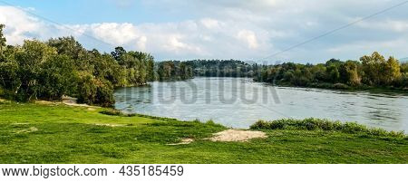 a view of the Ebro River passing through Miravet, Spain, in a panoramic format to use as web banner or header
