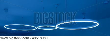 Ceiling With Round Modern Led Lamps. Suspended Fluorescent Lights Under The Ceiling. Careful Energy 