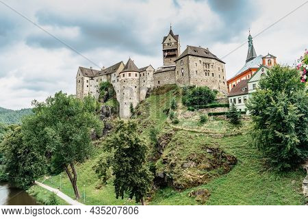 Panoramic View Of Famous Medieval Town Of Loket,elbogen, With Colorful Houses And Stone Castle Above