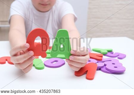 A Boy Holding Colorful Letters Q And A, Questions And Answers Concept, Solvation Kids Problems