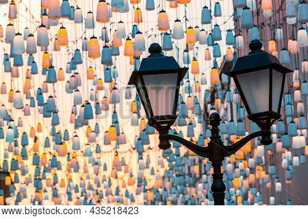 Street Lights On Stoleshnikov Lane. Moscow Pedestrian Street. Lights In The Dark. Beautiful Backligh