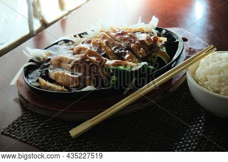 Japanese Teriyaki Chicken Dinner Served In Cast Iron Hot Plate