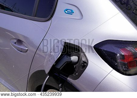 Bordeaux , Aquitaine  France - 09 30 2021 : Peugeot 208 Charging Ev E-208 Electric Car Vehicle Produ