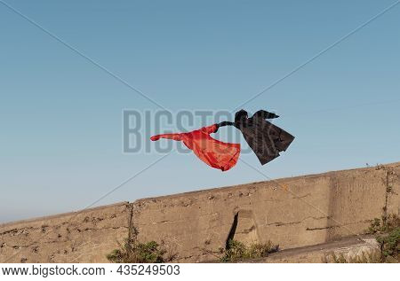 Red And Black Raincoat Fly, Hold Hand