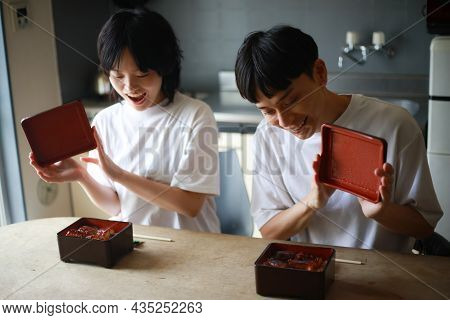 Image Of A Couple Eating Unaju At Home
