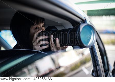 Woman Taking Pictures From Inside The Car