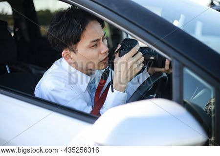 A Man Taking A Picture From Inside The Car