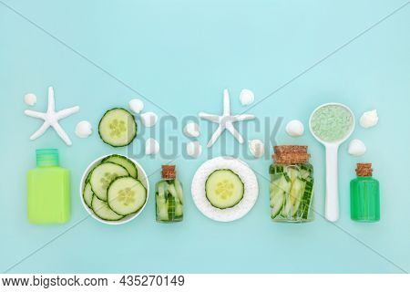 Cucumber skin health care for hydrating healing beauty treatment with slices, soap, lotion, gel and ex foliation salts. Healthy skincare concept. On blue background with seashells. Copy space.