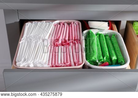 Open Cabinet Drawer With Menstrual Pads, Tampons And Pantyliners, Closeup