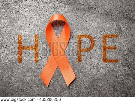 Orange Ribbon And Word Hope On Grey Background, Top View
