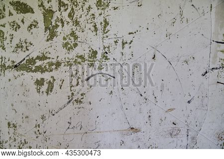 White Wall With Green Peeling Spots And Black Sharpie Graffiti Marks Background