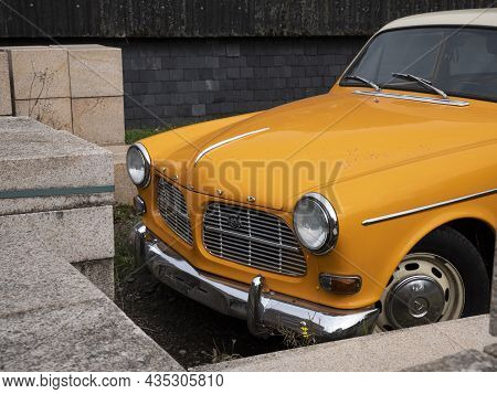 Stekene, Belgium, September 25, 2021, Front With Chrome Bumper Of An Orange Classic Car Volvo 122s