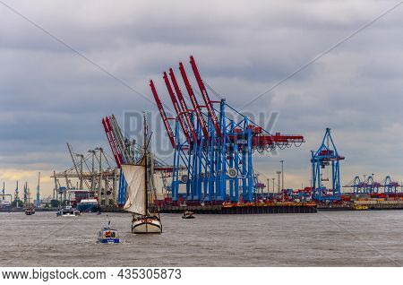 Hamburg, Germany, May 11. 2014. Harbor And Terminal Burchardkai At Cloudy Day. Ships Sailing Through