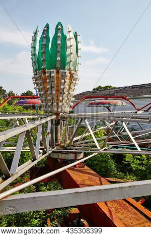Abandoned Amusement Park Ride Tilt-a-whirl With A Cactus In The Center Sitting Rusted In A Field