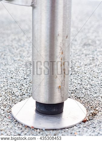 Construction Base In Soft Rubbery Tille. Chrome Steel Bar Ends In Safety Ground Of Workout Playgroun