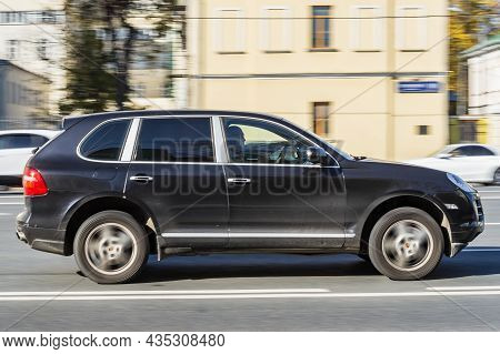 Moscow, Russia - October 2021: Old Porsche Cayenne 955 In Motion. Black Used Suv Drive On Street At 
