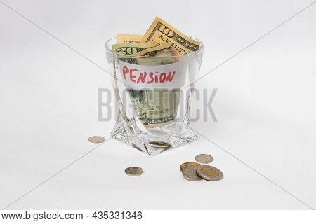 A Pile Of Dollars In A Whiskey Glass On A White Isolated Background. Retirement Savings In Dollars. 