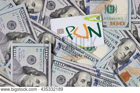 A Bunch Of Dollars And A Bank Card Close-up. The Background Is Made Of Dollars. Payment By Plastic C