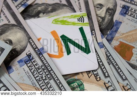 A Bunch Of Dollars And A Bank Card Close-up. The Background Is Made Of Dollars. Payment By Plastic C