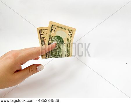 10 Dollars In The Hand Close-up On A White Isolated Background. A Ten-dollar Bill