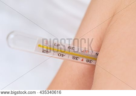 A Classic Mercury Thermometer Anderarm, In An Armpit Measuring Temperature Close Up, Cold , Flu And 