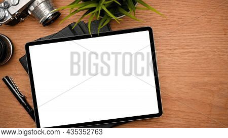 A Modern Photographer Desk With Graphic Tablet Mockup On Wooden Table. Top View