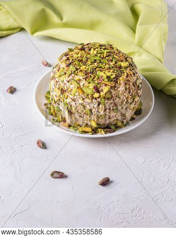Sesame Halva With Pistachios On Top, Few Scattered Nuts, Green Linen Napkin. Turkish Delight. Tradit