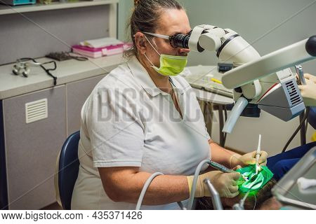 Dental Treatment With A Microscope. Man Having Teeth Examined At Dentists. Appointment At The Dentis