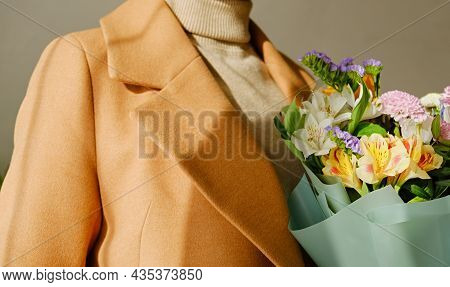 A Woman In A Beige Coat Holds A Beautiful Autumn Bouquet In Her Hands. Depersonalization Concept. Cl
