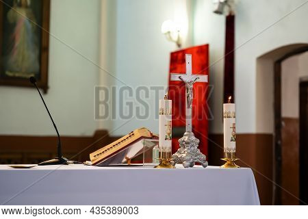 The Altar Of A Catholic Priest With A Bible On The Table.