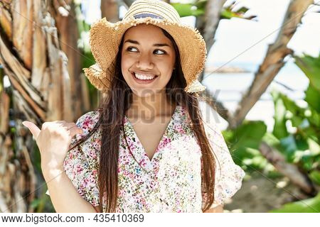 Young brunette woman outdoors on a sunny day of summer scared and amazed with open mouth for surprise, disbelief face 