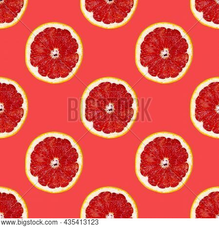 Grapefuit Slices Seamless Pattern Over Red Background, Top View