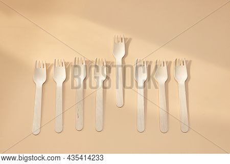 Wooden Spoon, Fork, Paper Cups On Beige Background. Disposable Tableware Made Of Natural Materials. 