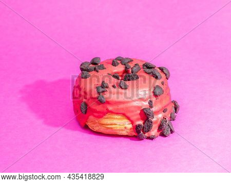 Red Cronuts On A Pink Background. High Quality Photo