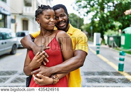 Young afircan american couple smiling happy and hugging at the city.
