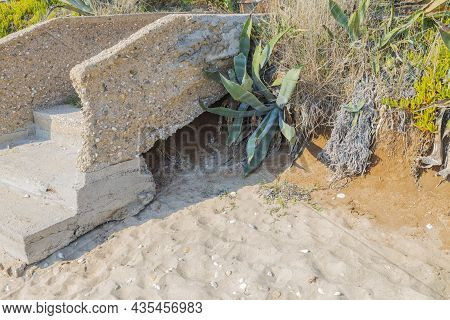 Close Up View Of Okd Broken Abandoned Stone Stair Part On Sandy Landscape. Greece.