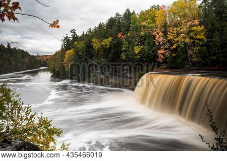 Beautiful Panoramic Autumn Photograph Of Upper Tahquamenon Falls In Michigan With Water Cascading In