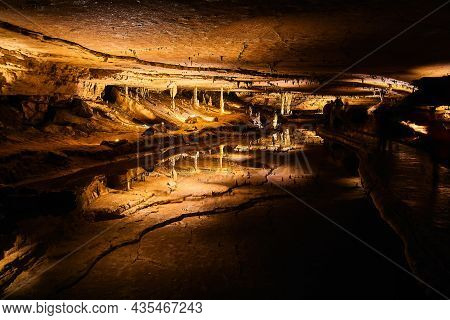Cave Formations Of Stalagmites And Stalactites Reflecting In Perfectly Clear Water That Is Like A Mi