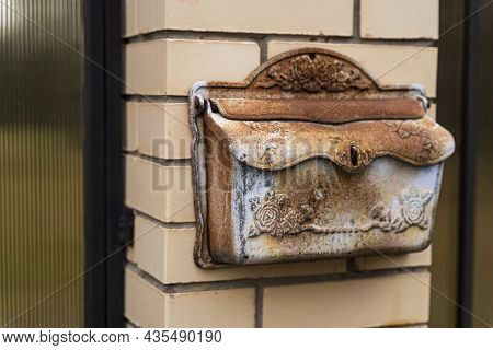 Mailbox Of A Private House, A Mailbox Made Of Black Metal Installed On A Brick Fence Of A Private Re