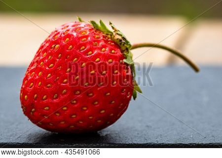 Close Up Of Fresh Strawberry Showing Seeds Achenes. Details Of A Fresh Ripe Red Strawberry.