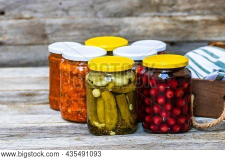 Jars With Variety Of Canned Vegetables And Fruits, Jars With Zacusca. Preserved Food Concept In A Ru