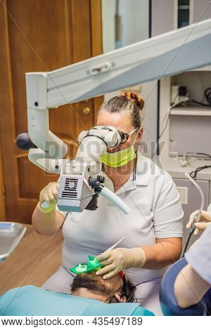Dental Treatment With A Microscope. Man Having Teeth Examined At Dentists. Appointment At The Dentis