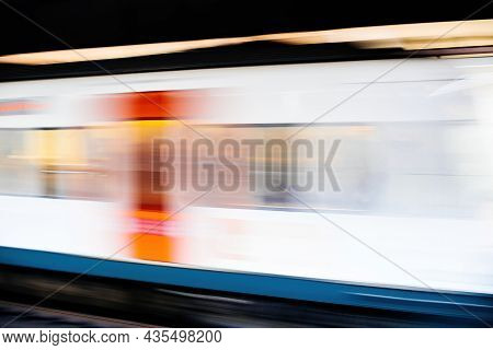 Side Ivew Of Defocused View Of Metro Train Arrival In Station Platform With No People - Light Trails