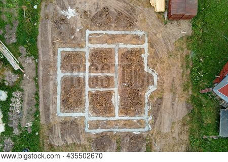 Top Down Aerial View Of Building Works Of New House Concrete Foundation On Construction Site.