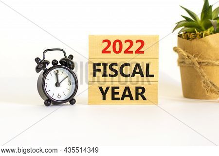 2022 Fiscal New Year Symbol. Concept Words '2022 Fiscal Year' On Wooden Blocks. Black Alarm Clock, H