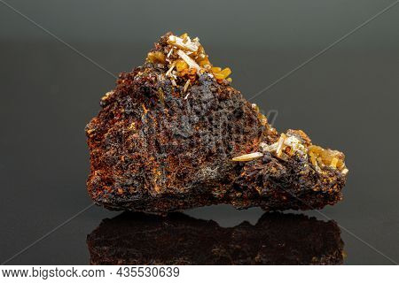 Macro Mineral Wulfenite Stone On A Black Background Close-up