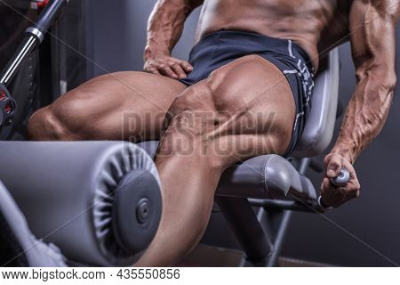 Image Of A Powerful Athlete Doing A Quadriceps Exercise In A Gym. Fitness And Bodybuilding Concept.