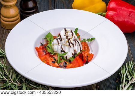 Salad With Buratta Cheese And Tomatoes On Plate