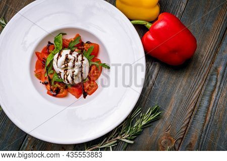 Salad With Buratta Cheese And Tomatoes On Plate
